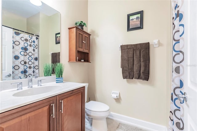 bathroom featuring vanity, tile patterned flooring, and toilet