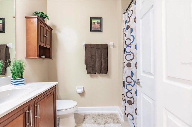 bathroom featuring tile patterned floors, vanity, and toilet