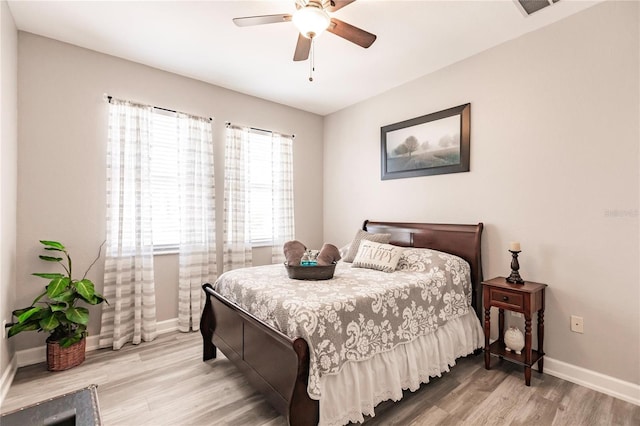 bedroom with wood-type flooring and ceiling fan