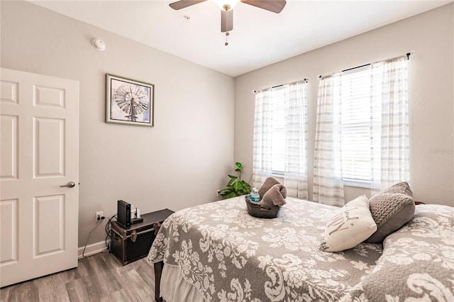 bedroom with light hardwood / wood-style flooring and ceiling fan