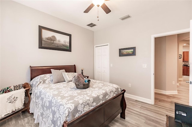 bedroom featuring a closet, light hardwood / wood-style floors, and ceiling fan