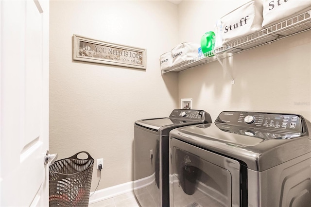 washroom with separate washer and dryer and light tile patterned floors