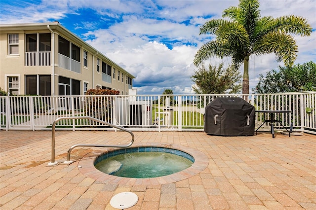 view of pool featuring an in ground hot tub, a patio area, and grilling area