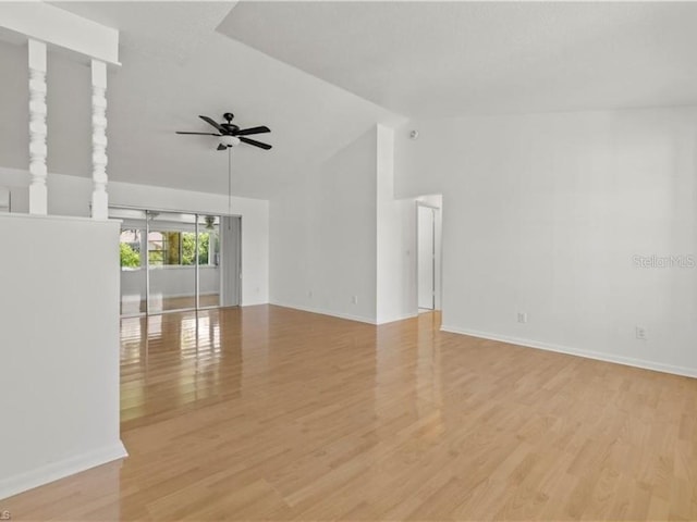 empty room featuring vaulted ceiling, light hardwood / wood-style floors, and ceiling fan