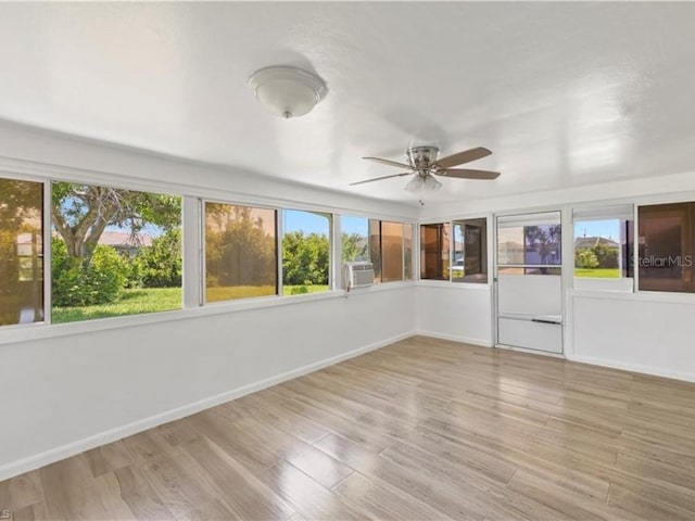 unfurnished sunroom featuring ceiling fan and cooling unit