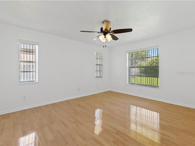 spare room with light hardwood / wood-style floors and ceiling fan