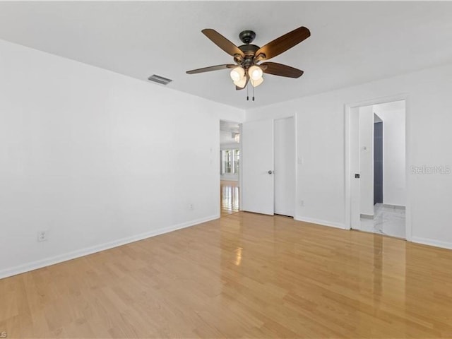 empty room with light wood-type flooring and ceiling fan