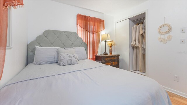 bedroom with light wood-type flooring and a closet