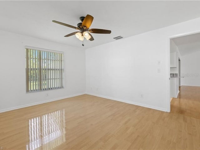 spare room featuring ceiling fan and light hardwood / wood-style flooring