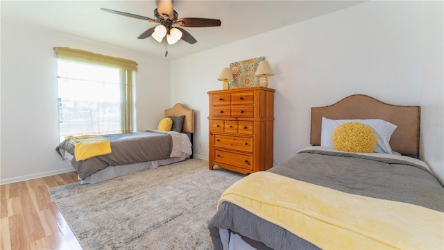 bedroom with ceiling fan and hardwood / wood-style flooring