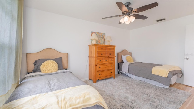 bedroom featuring light wood-type flooring and ceiling fan