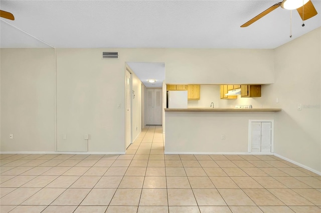 interior space featuring light tile patterned floors and ceiling fan