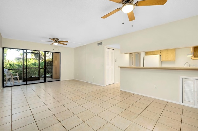 tiled spare room with ceiling fan and sink