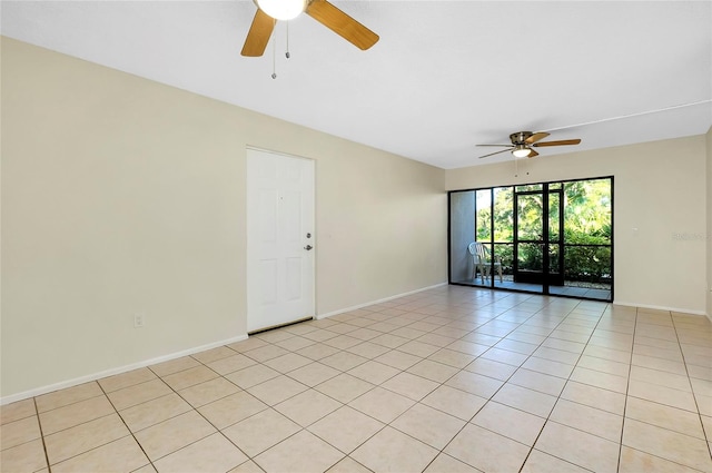 empty room with ceiling fan and light tile patterned floors