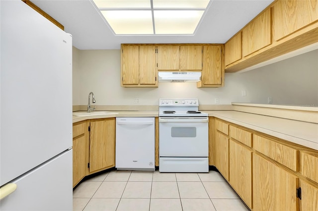 kitchen featuring light tile patterned flooring, white appliances, and sink