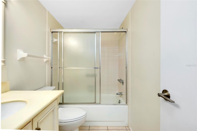 full bathroom featuring tile patterned floors, toilet, vanity, and combined bath / shower with glass door