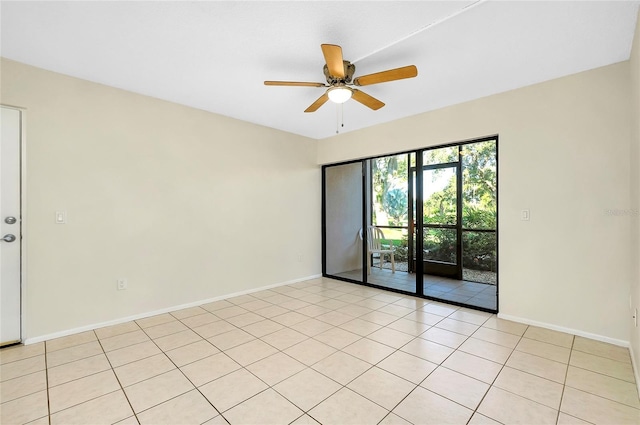 tiled spare room with ceiling fan