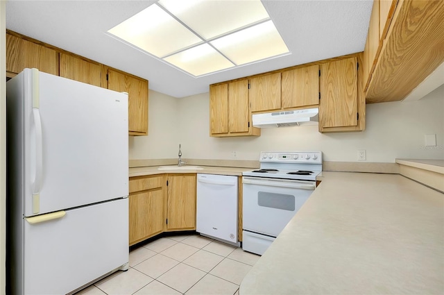 kitchen featuring sink, light tile patterned floors, and white appliances