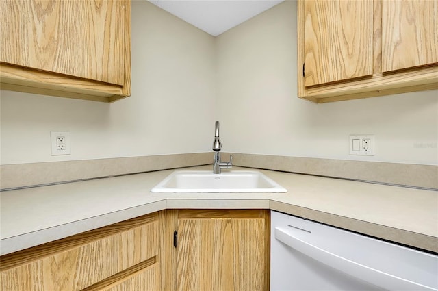 kitchen featuring dishwasher, light brown cabinets, and sink