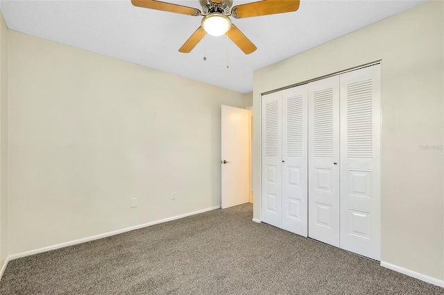 unfurnished bedroom featuring ceiling fan, a closet, and dark carpet