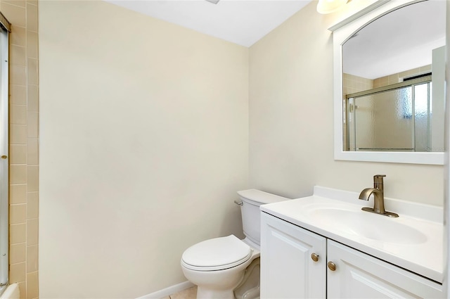 bathroom with vanity, toilet, and a shower with shower door