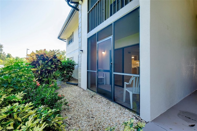 view of side of home with a sunroom