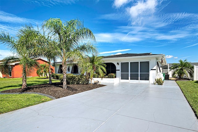 ranch-style house with a garage and a front yard