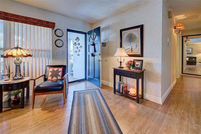 entrance foyer with a textured ceiling and hardwood / wood-style flooring