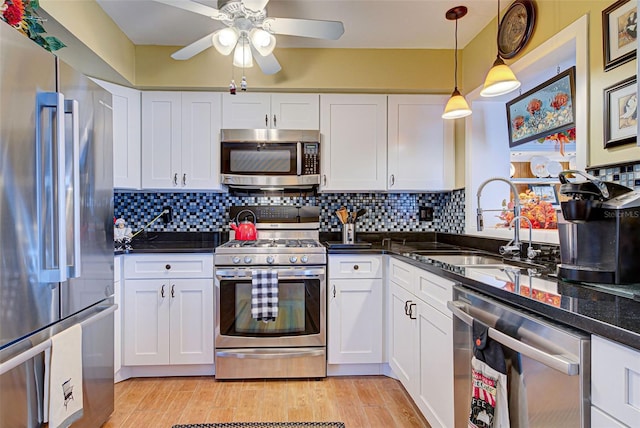 kitchen featuring white cabinets, appliances with stainless steel finishes, and sink