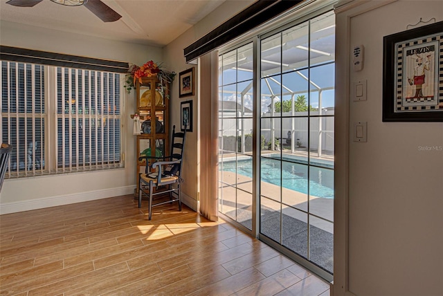 doorway to outside featuring light wood-type flooring and ceiling fan