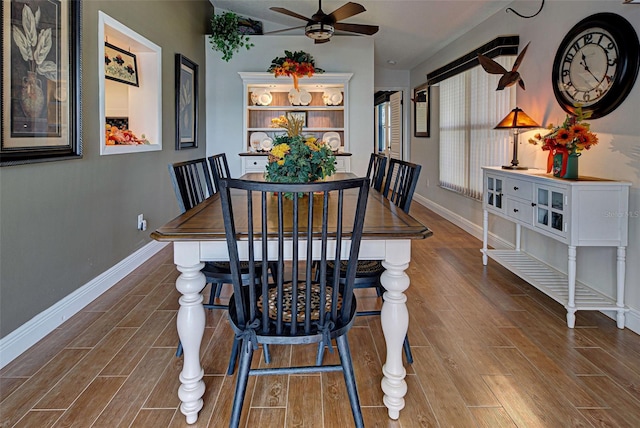 dining space featuring wood-type flooring and ceiling fan