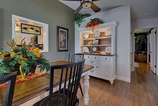 dining area with a textured ceiling, wood-type flooring, and ceiling fan