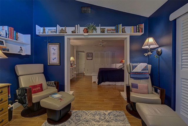 bedroom with wood-type flooring, lofted ceiling, and a closet