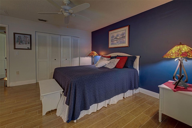 bedroom featuring a closet, wood-type flooring, and ceiling fan