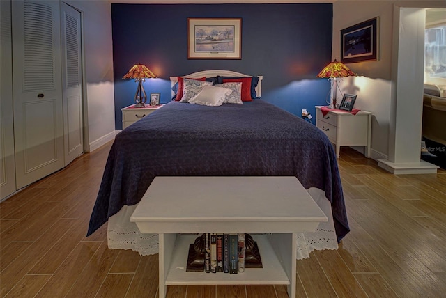 bedroom with light wood-type flooring and a closet