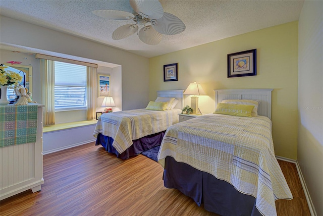 bedroom featuring ceiling fan, a textured ceiling, and hardwood / wood-style floors