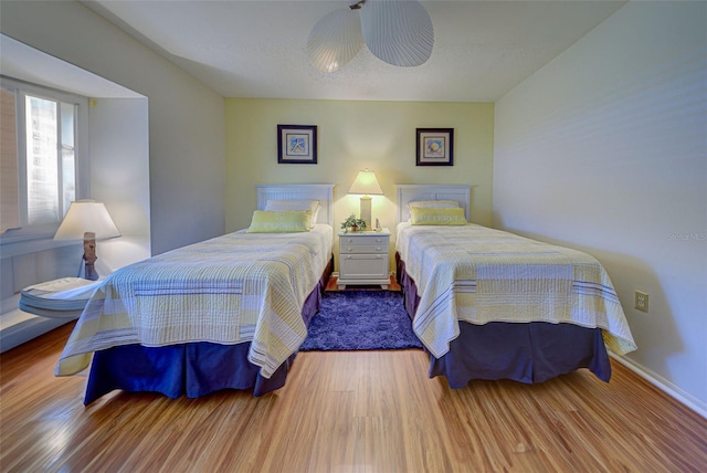 bedroom featuring a textured ceiling, hardwood / wood-style floors, and ceiling fan