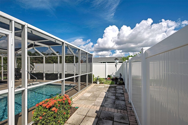 view of swimming pool with a lanai and a patio area