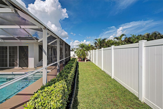 view of yard featuring a lanai and a fenced in pool