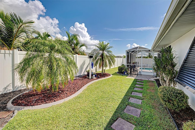 view of yard featuring a fenced in pool, a lanai, and a patio area