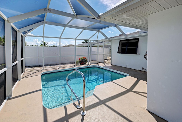 view of swimming pool with glass enclosure and a patio area