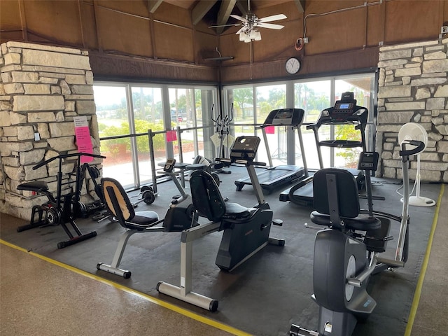 gym with high vaulted ceiling, ceiling fan, and a healthy amount of sunlight