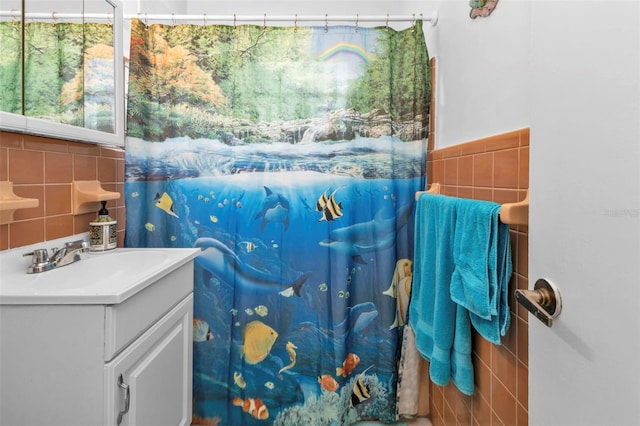 bathroom featuring tile walls and vanity