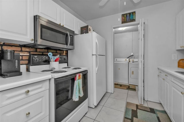 kitchen featuring washing machine and dryer, white cabinetry, light tile patterned floors, white electric stove, and ceiling fan