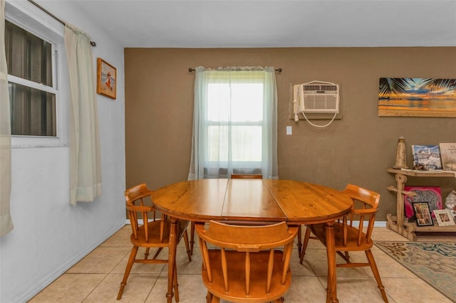 dining space featuring an AC wall unit and tile patterned floors