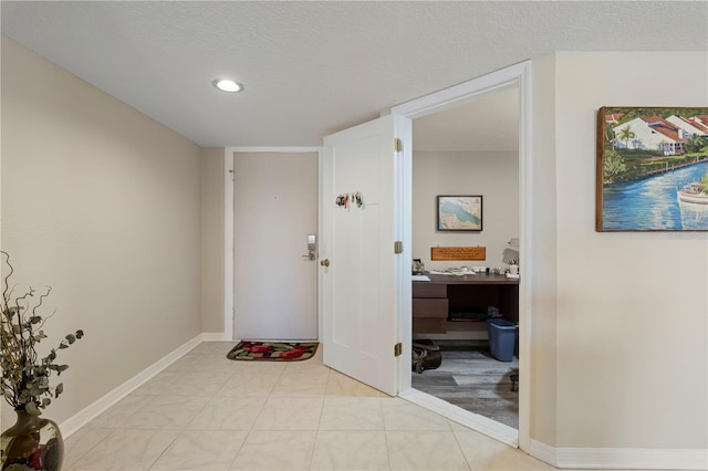 interior space with a textured ceiling and built in desk