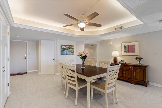 dining room featuring a tray ceiling and ceiling fan