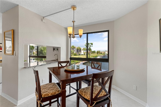 dining area with a chandelier and a textured ceiling