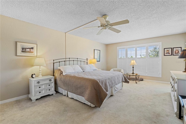 carpeted bedroom with a textured ceiling and ceiling fan