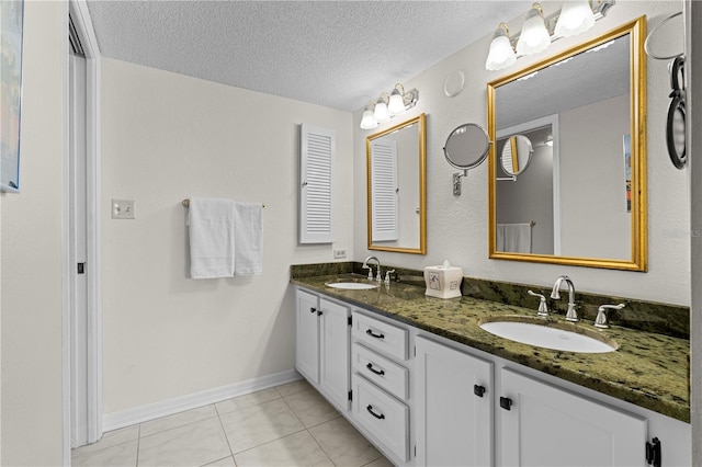 bathroom featuring tile patterned flooring, a textured ceiling, and vanity